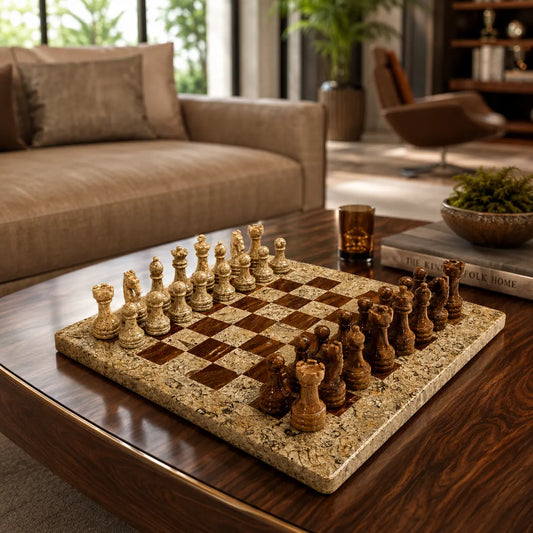 A stone chess set with a beige and brown speckled board and cream and dark wooden chess pieces, arranged on a dark wood coffee table in a modern living room setting.